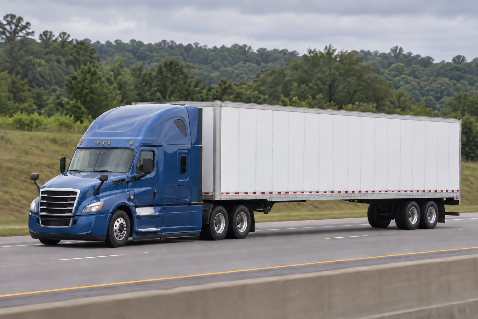 Illustrative blue tractor and white freight trailer traveling beside a green tree line